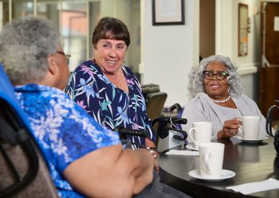 residents at the La Jolla Nursing and Rehab facility drinking coffee at a table