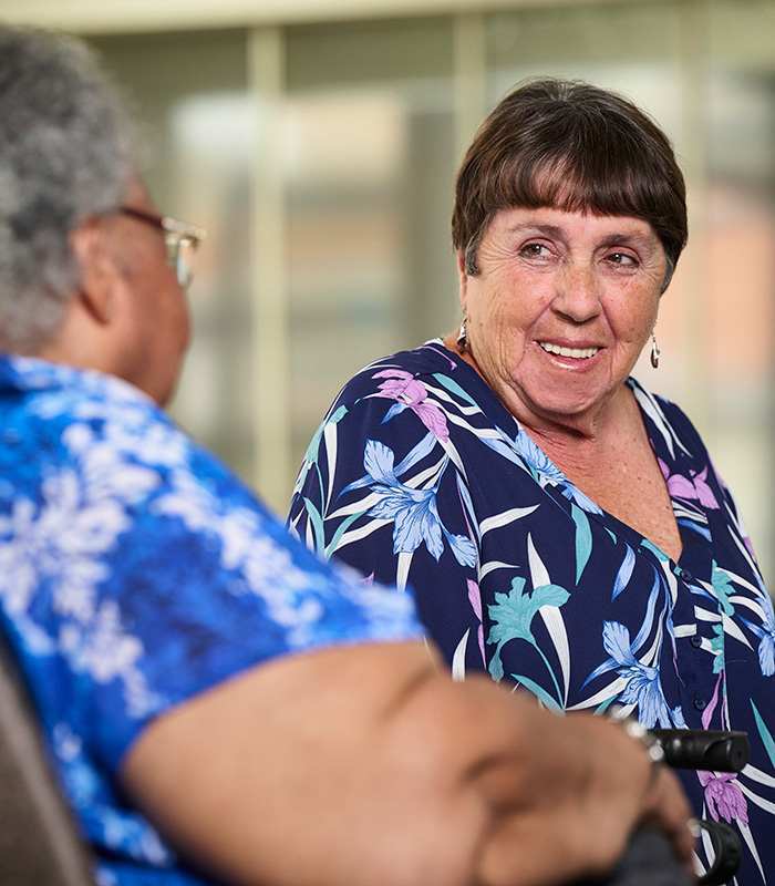 two residents at the La Jolla Nursing and Rehab facility talking at a table